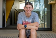 US scholarship for Heyfield runner Rachel O'Brien sits smiling on Heyfield FNC's stairs