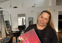 Arch Beauty award finalist Taylor Peatling, owner of Arch Beauty, holds her ASWBAC finalist letter.